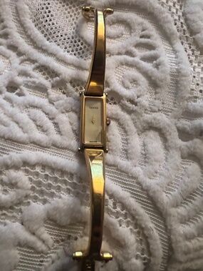 a vintage Gucci 1500L gold-plated ladies' bangle watch.